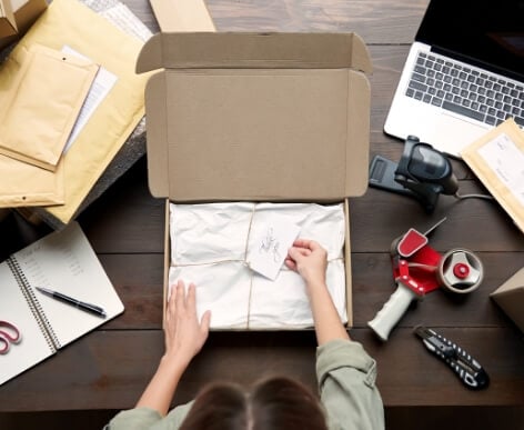 A woman packing products together